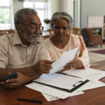 senior couple disussing invoices