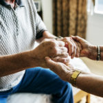 Senior couple holding hands