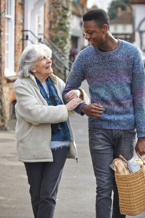 caregiver walking with a senior after shopping