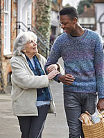 caregiver walking with a senior after shopping